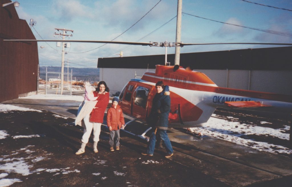 Deborah Murray with family and helicopter in the background